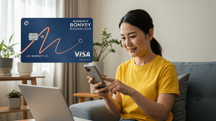 A woman with long dark hair tied back, wearing a yellow t-shirt, is sitting on a gray couch using her smartphone. In the upper left corner, there is a graphic of a Marriott Bonvoy Boundless Visa Signature credit card