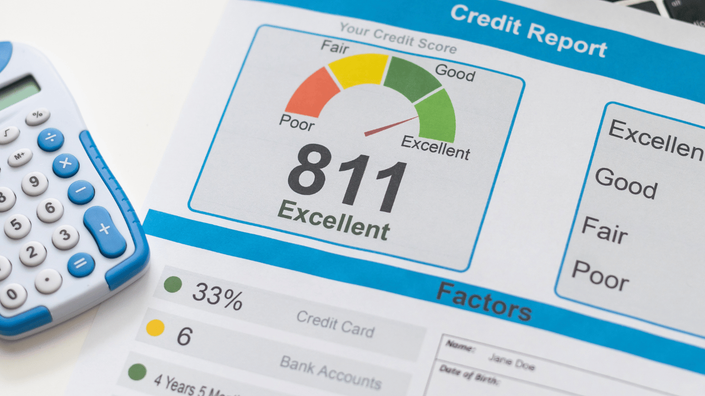 A printed credit report showing a high credit score of 811 marked as "Excellent." A blue and white calculator is placed next to the report, highlighting financial analysis and credit evaluation.