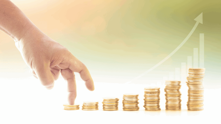 A hand walking up stacks of gold coins that gradually increase in height, with an upward arrow in the background, symbolizing growth and progress in Investing in Gold.